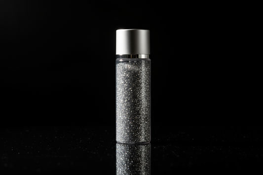 Plastic bottle of silver glitter on black background